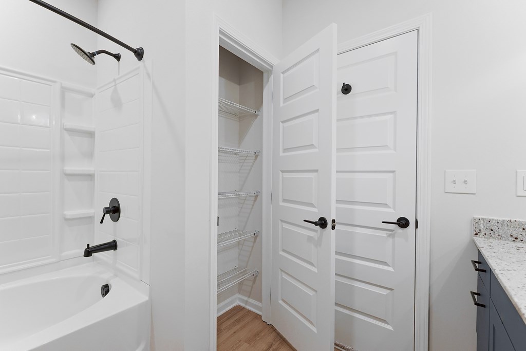 A white door is open to a pantry.