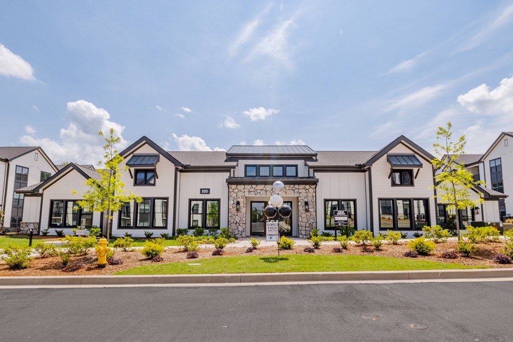 A row of houses with a clear blue sky above them.