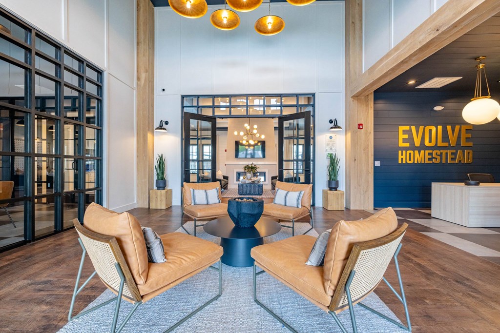 A modern office lobby with a blue carpet and tan chairs.