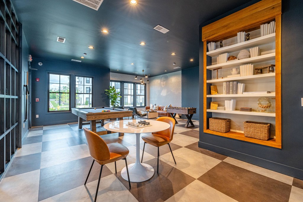 A dining room with a round table and chairs.