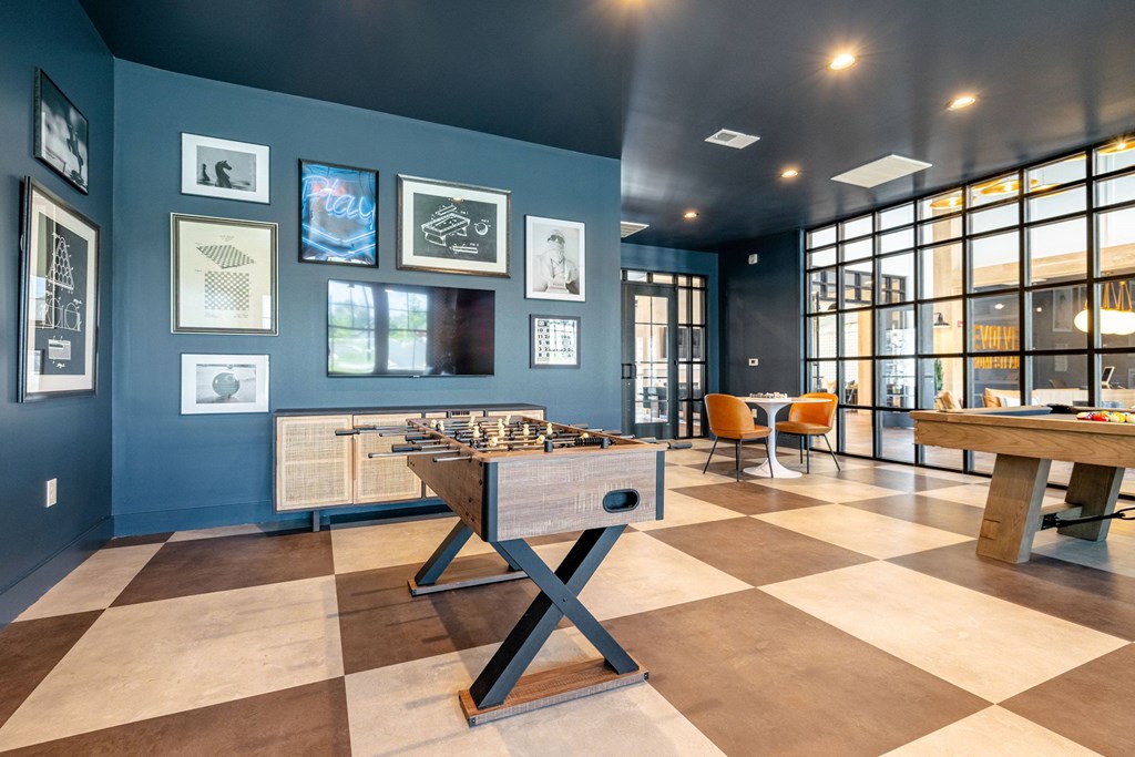 A room with a blue wall and a checkered floor.