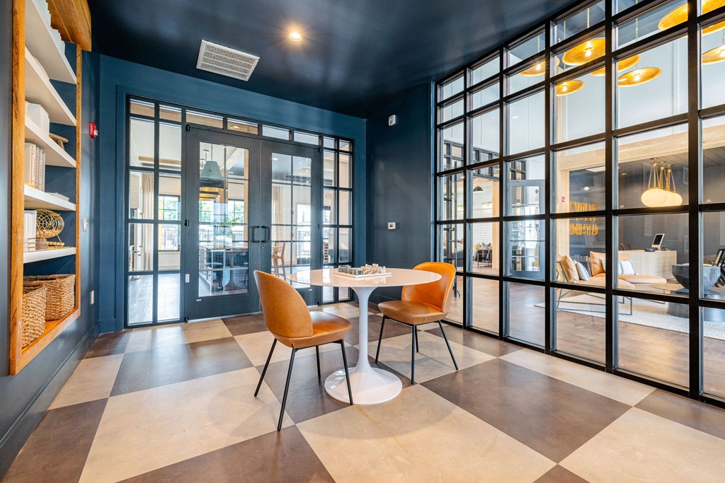 A dining area with a table and chairs.