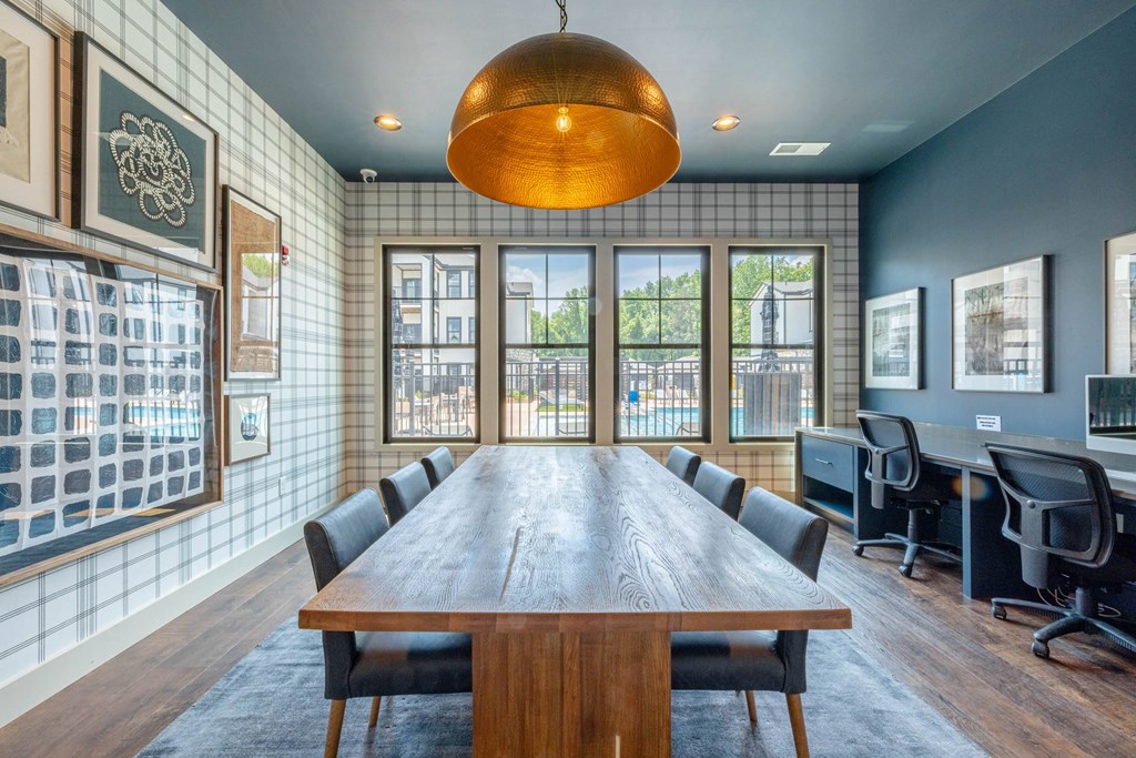 A conference room with a long table and chairs.