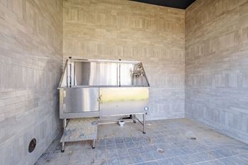 A stainless steel tank is in a room with tan walls.