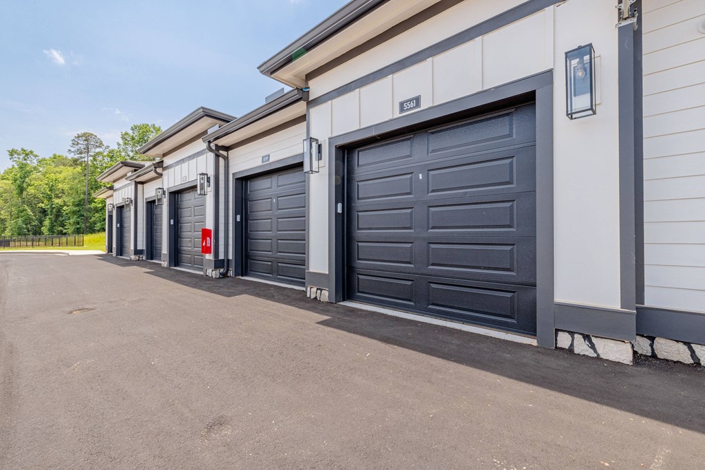 A series of storage units with doors and windows are lined up in a row.