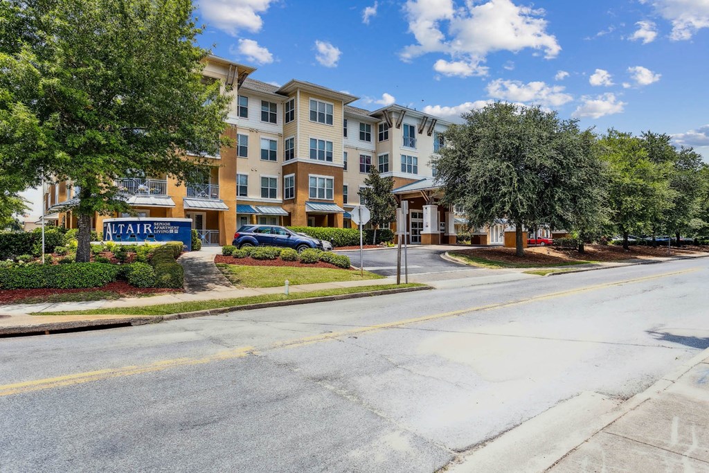 an empty street in front of an apartment building