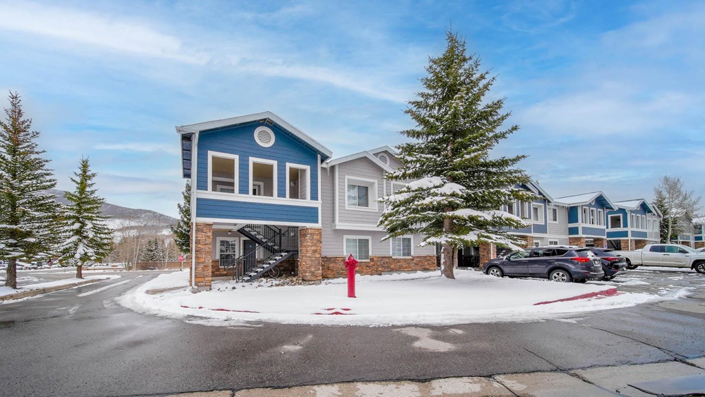 a red fire hydrant on the corner of a street
