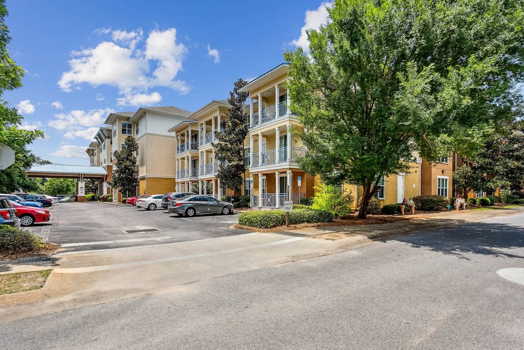 an empty parking lot in front of an apartment building