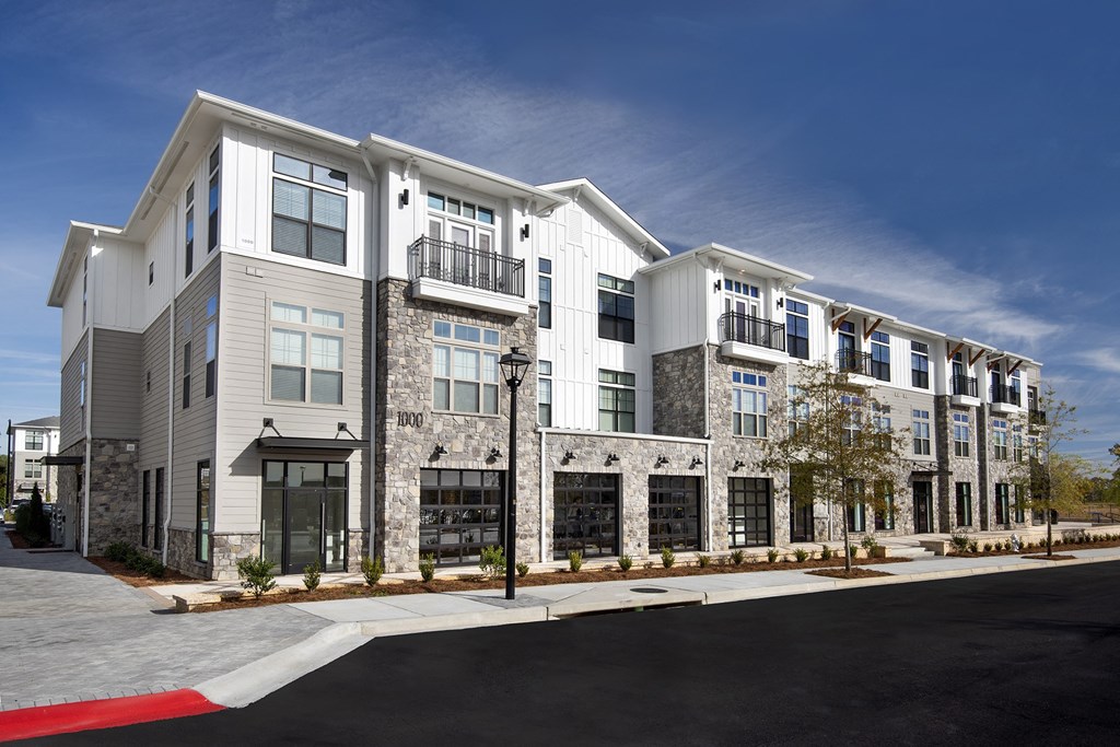 a rendering of a new apartment building on a street corner