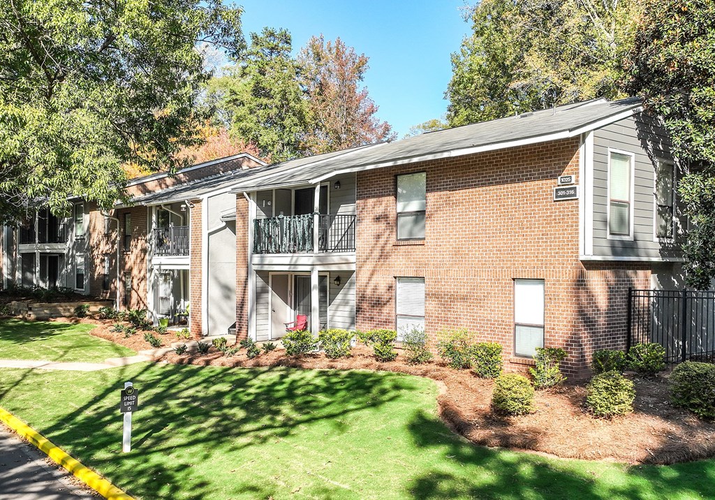 our apartments feature a spacious courtyard with green grass and trees