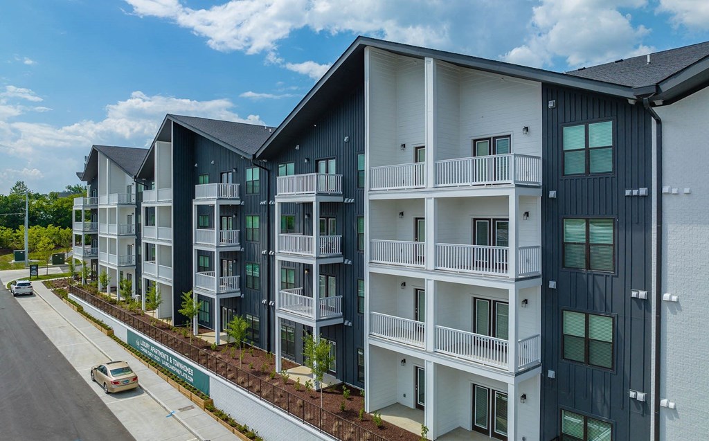 an exterior view of an apartment building on a city street