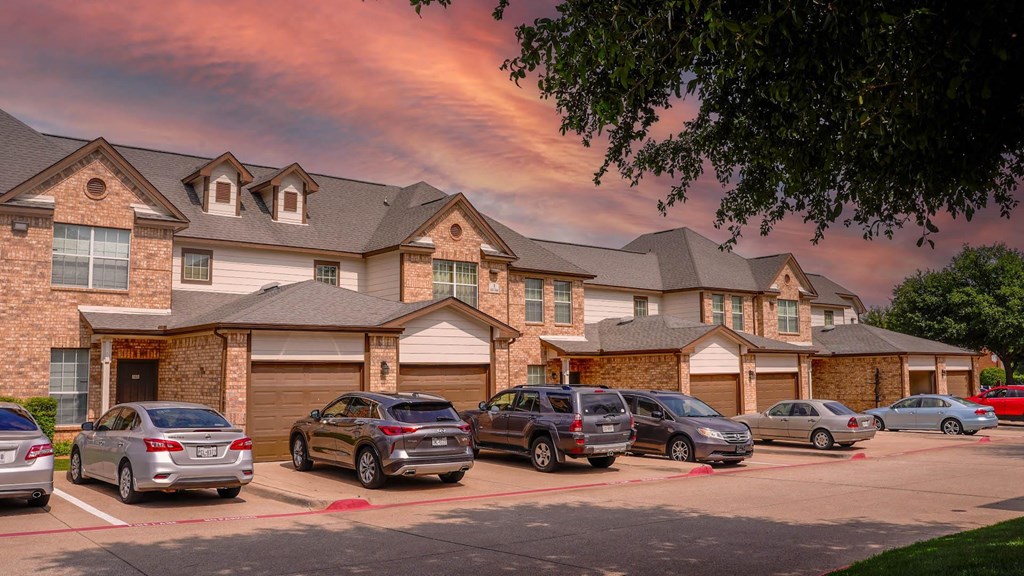a row of cars parked in front of a house