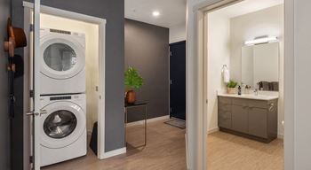 a washer and dryer in a bathroom in a 555 waverly unit