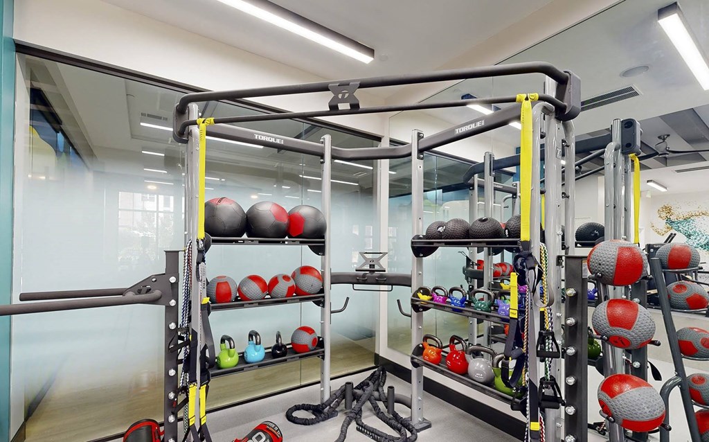 a home gym with weights and equipment on shelving