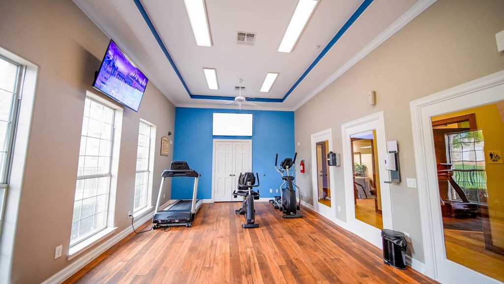 the gym at the district at highland village apartments