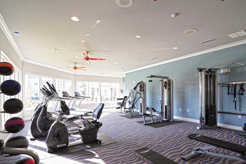 a gym with a lot of exercise equipment in it