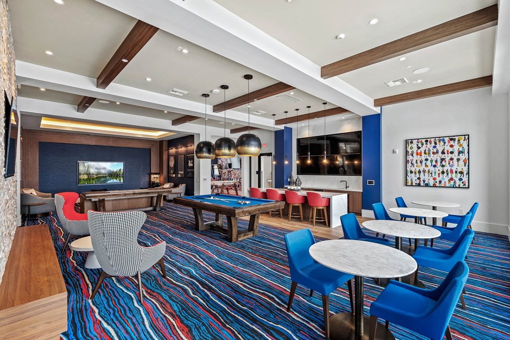 a lounge area with a pool table and tables and chairs at Altis Blue Lake, Lake Worth, Florida