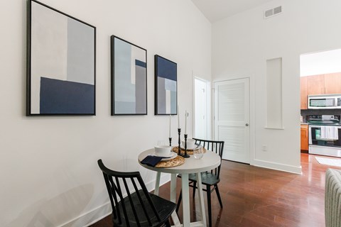 A dining room with a table and chairs.