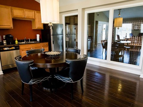 a kitchen and dining room with a table and chairs