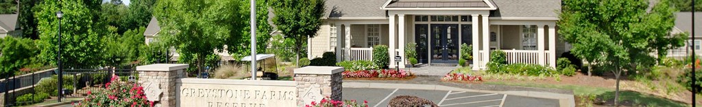 a house with a porch and a driveway and trees
