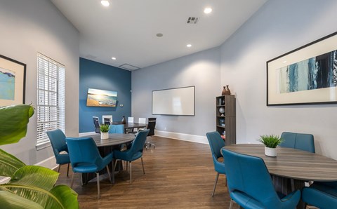 A dining room with blue chairs and a wooden table.