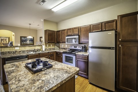 a kitchen with stainless steel appliances and granite counter tops