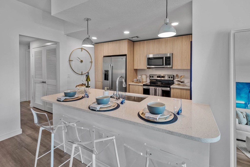 a kitchen with a counter top and a sink at Altis Blue Lake, Lake Worth, FL