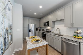 a kitchen with stainless steel appliances and granite counter tops