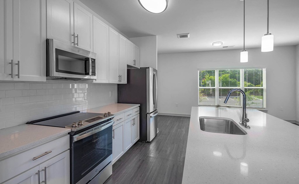 a kitchen with white cabinets and a sink