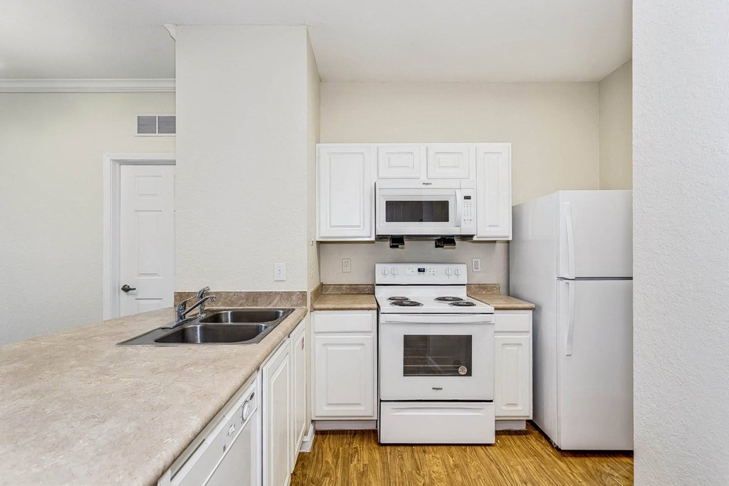 a kitchen with white appliances and white cabinets