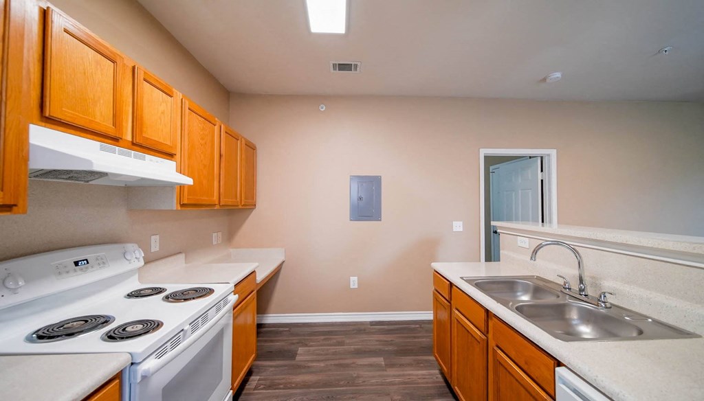 a kitchen with a stove top oven and a sink