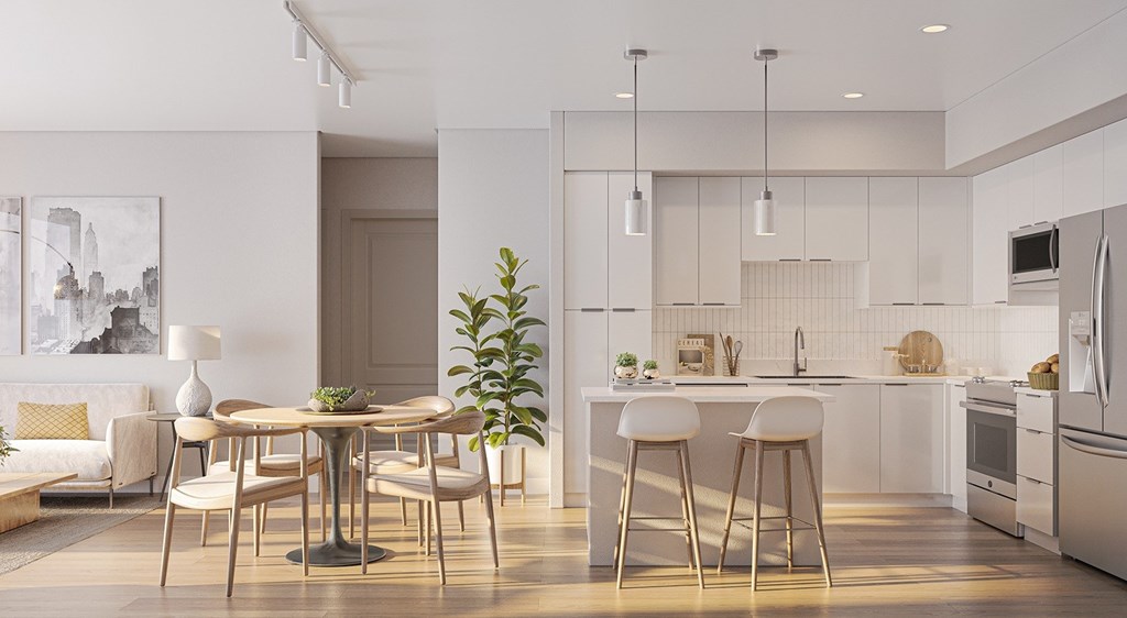 A modern kitchen with a dining table and chairs.