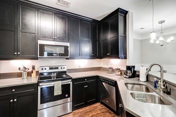 kitchen with appliances and quartz counters