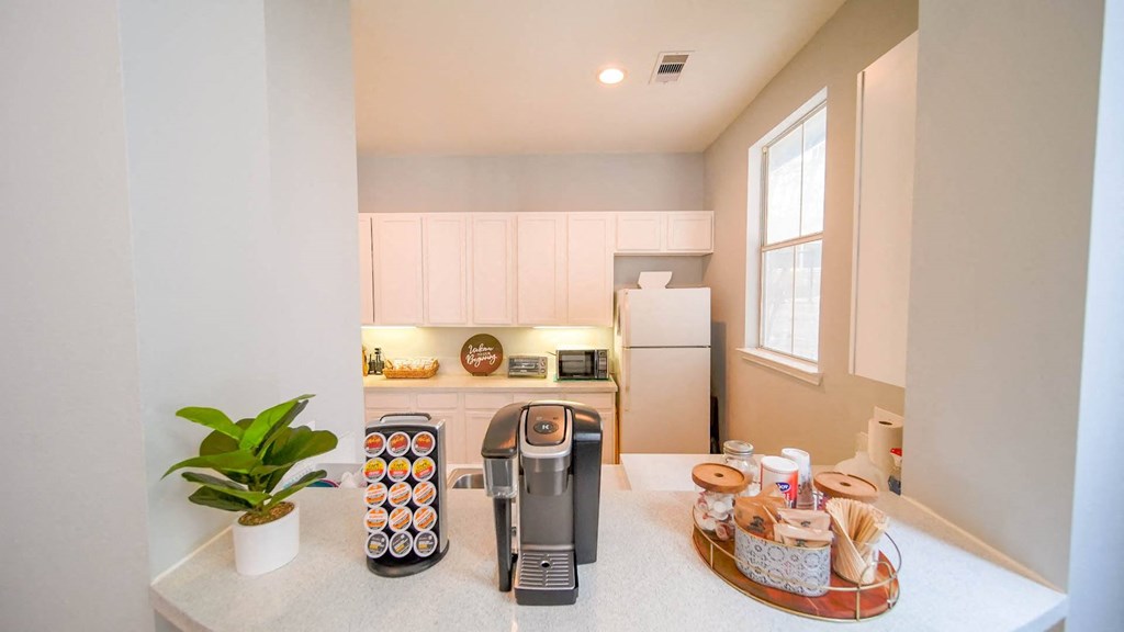 a kitchen with a coffee maker on the counter