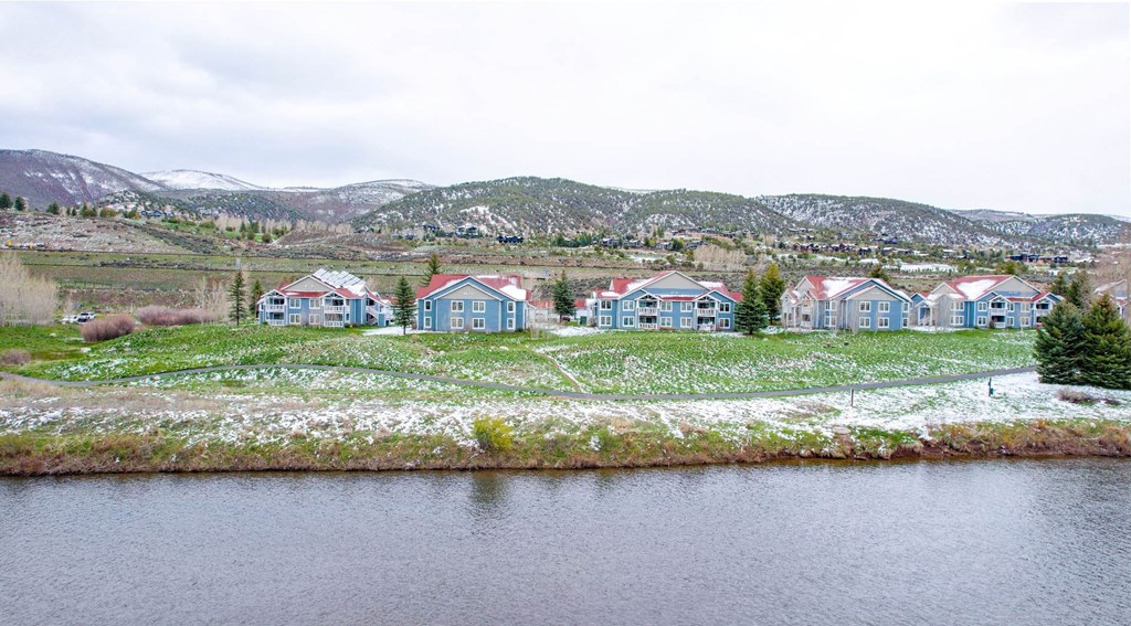 a group of colorful houses next to a body of water