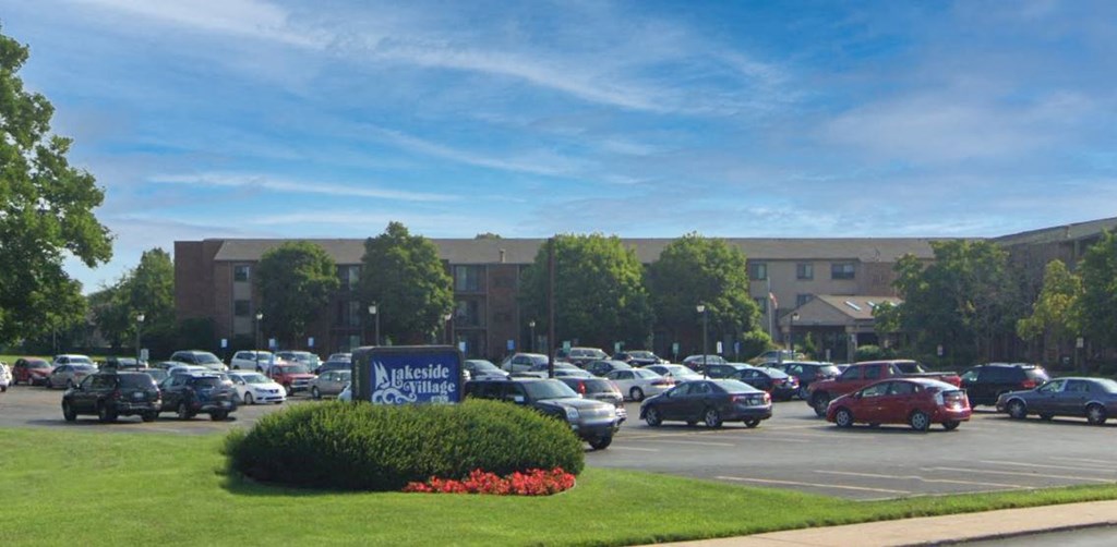a parking lot with cars and a building in the background