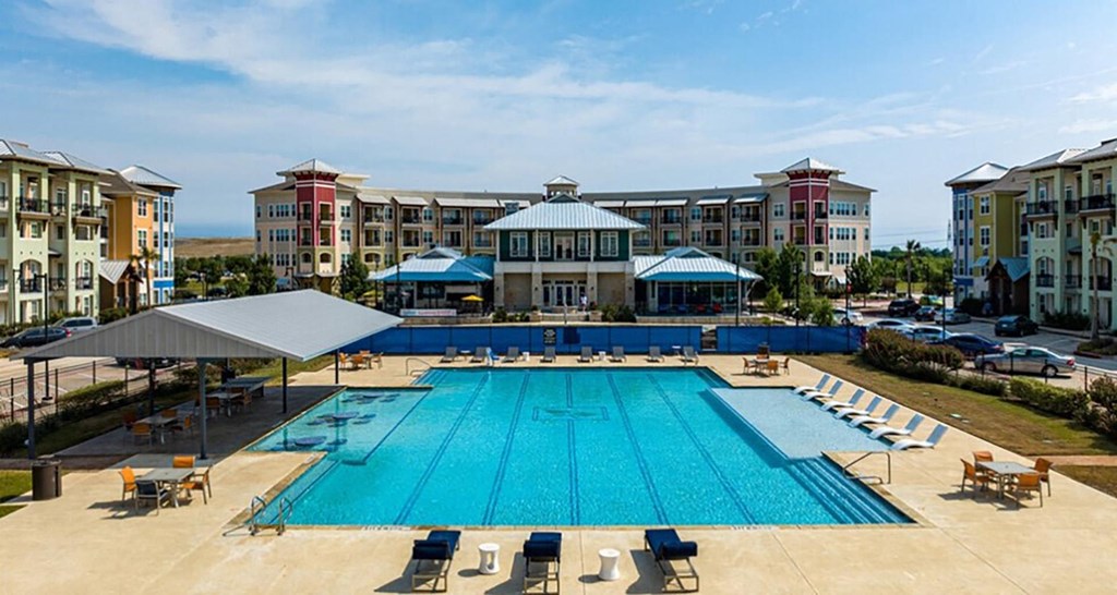 an aerial view of a swimming pool with apartments in the background
