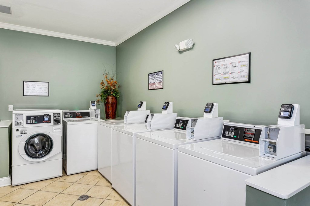a laundromat with four washes and dryers in a launderette