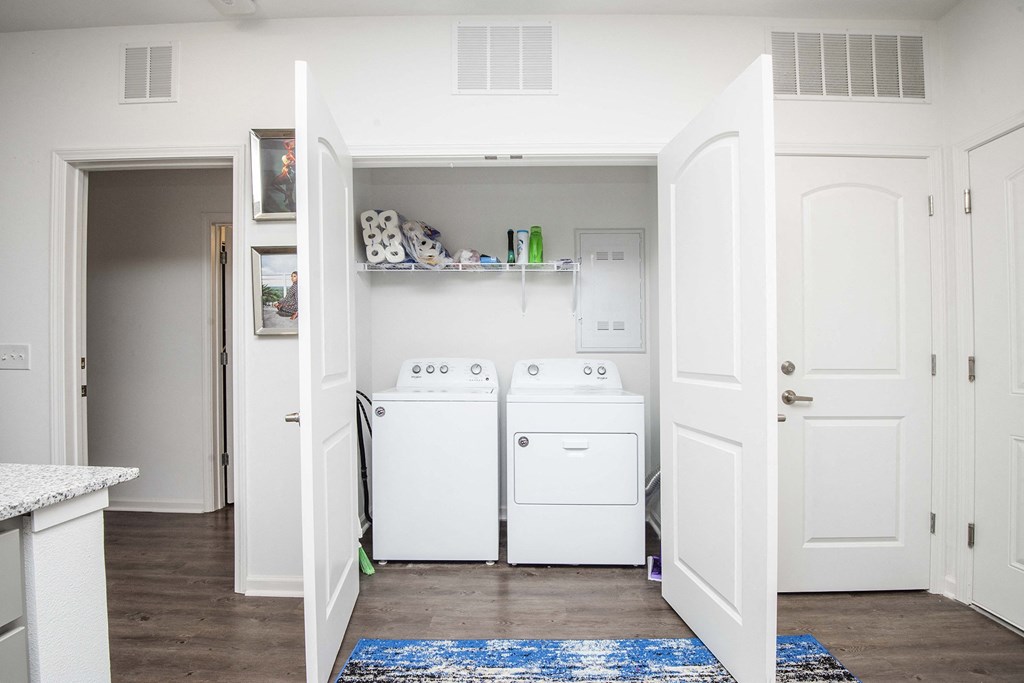 A small laundry room with a washer and dryer.