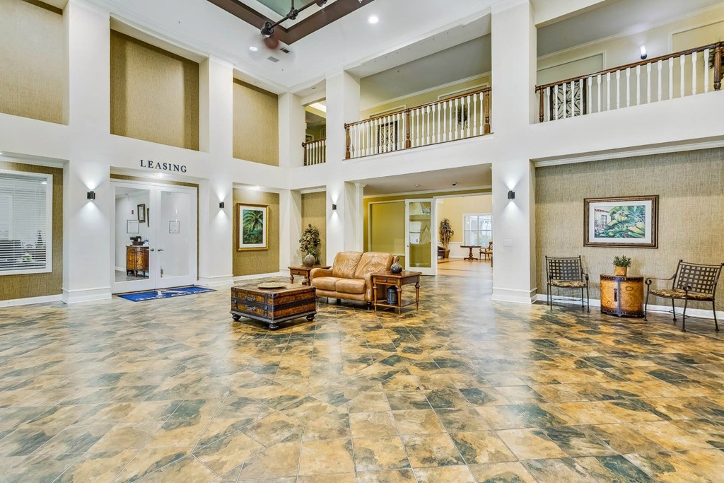 a large lobby with furniture and a staircase