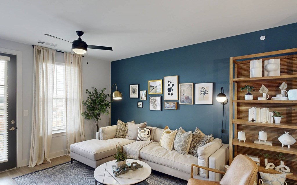 a living room with a blue accent wall and a white couch