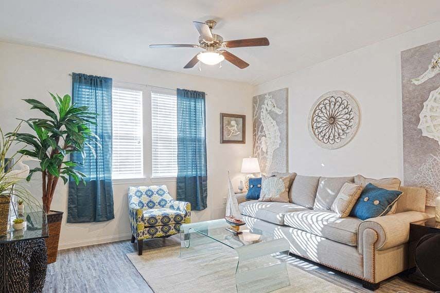 a living room with a couch and a ceiling fan