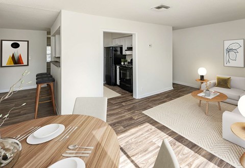 A modern dining room with a wooden table set for two.