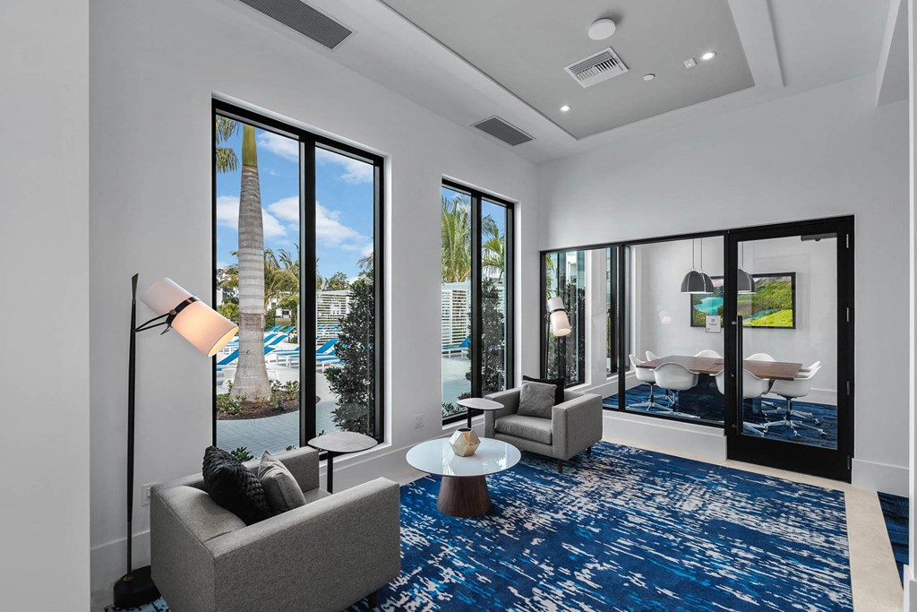a living room with a view of a pool and a blue rug at Altis Blue Lake, Lake Worth, FL, 33467