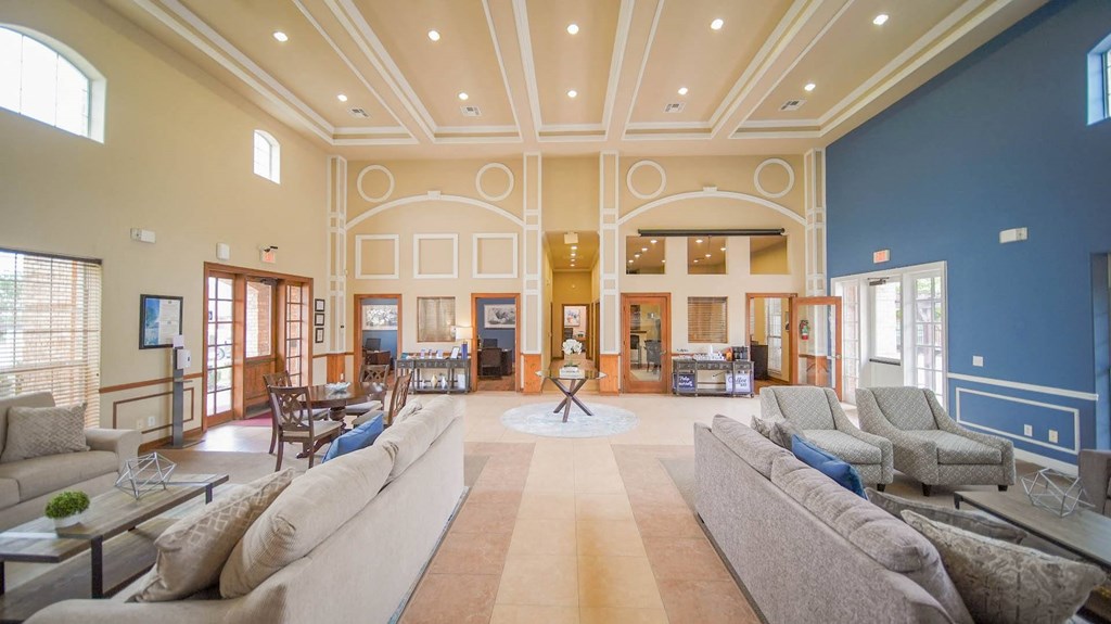 a large living room with couches and a table