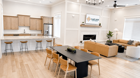 A modern kitchen with wooden cabinets and a black island.