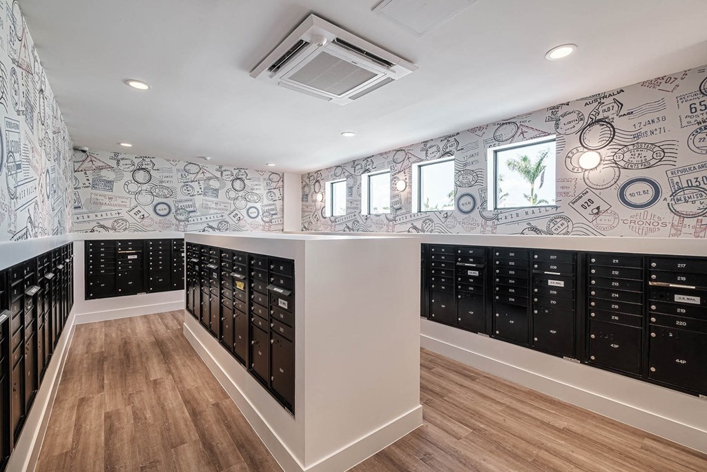 a walk in closet with a bunch of lockers and a wall covered in wallpaper at Altis Blue Lake, Florida, 33467