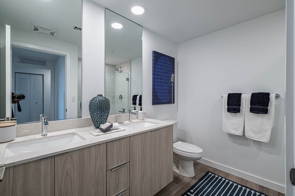 a bathroom with a sink and a toilet and a mirror at Altis Blue Lake, Lake Worth, FL, 33467