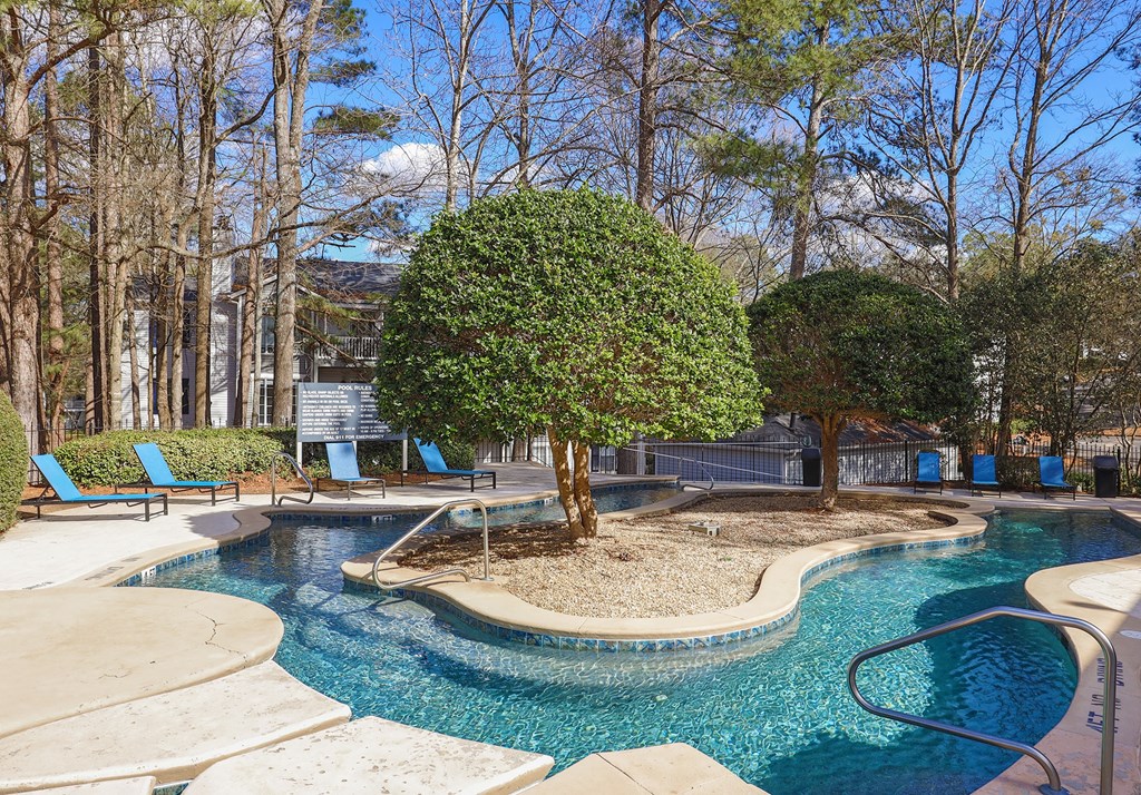 a swimming pool with a tree in the middle of it