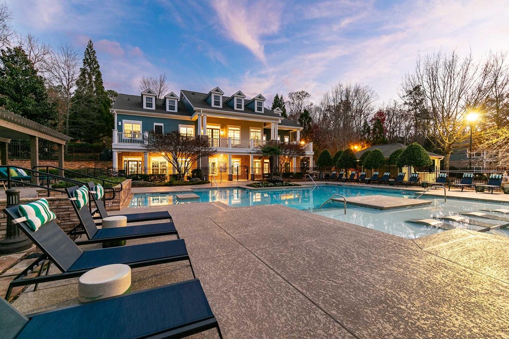 A large house with a pool in front of it.